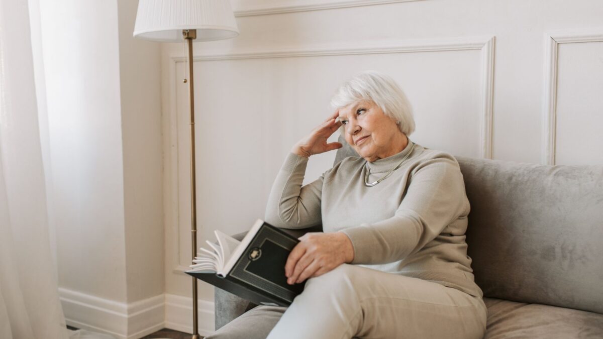 lady reading book waiting for heating engineer
