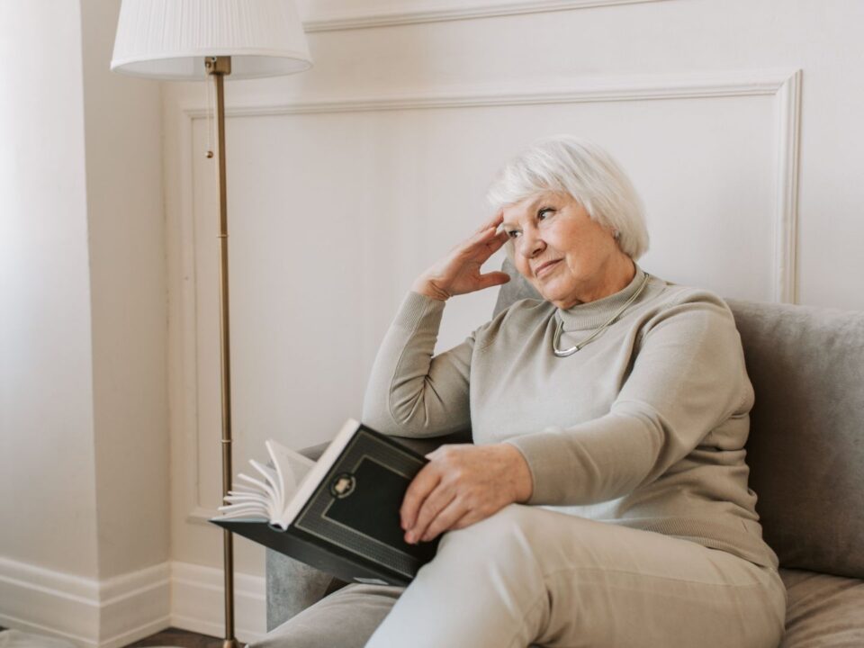 lady reading book waiting for heating engineer